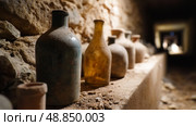 Historical artifacts displayed in ancient underground cellar with stone walls and soft lighting. Стоковое AI-изображение, AI-художник Сергей Толмачёв / Фотобанк Лори