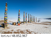 Wooden ritual pillars with colorful ribbons on cape Burkhan. Стоковое фото, фотограф Юлия Белоусова / Фотобанк Лори