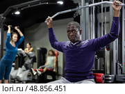 African american man is engaged in a simulator for development of back muscles. Стоковое фото, фотограф Яков Филимонов / Фотобанк Лори