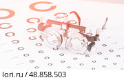 The doctor's table is equipped with various test glasses of different diopters, demonstrating the variety of tools for accurate diagnosis. Стоковое фото, фотограф Скрипачев Антон / Фотобанк Лори