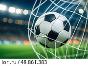 Football ball hitting net in illuminated stadium, symbolizing goal, sports success, competition, teamwork, match excitement, athletic victory, dynamic action, night tournament. Стоковое AI-изображение, AI-художник Павел Муравьев / Фотобанк Лори