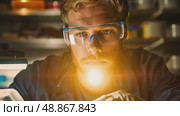 A scientist focuses intently on experiments in a well-equipped laboratory, emphasizing precision and dedication to innovative research methods. Стоковое AI-видео, аниматор Данила Большаков / Фотобанк Лори