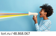 African american woman holding a megaphone and yelling loudly into it to amplify her voice. Стоковое AI-изображение, AI-художник Данила Большаков / Фотобанк Лори