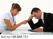 Woman shouting at a man across a desk. Стоковое фото, агентство Ingram Publishing / Фотобанк Лори