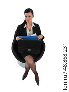 Businesswoman reviewing her files before a meeting. Стоковое фото, агентство Ingram Publishing / Фотобанк Лори