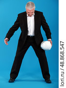 An invisible object passing between a man&rsquo;s legs. Стоковое фото, агентство Ingram Publishing / Фотобанк Лори