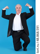 businessman proudly showing his muscles. Стоковое фото, агентство Ingram Publishing / Фотобанк Лори