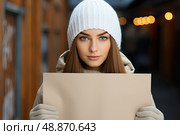 Visions Unveiled: A Woman in a White Hat Conveys Her Message Through a Captivating Sign. Стоковое AI-изображение, AI-художник Данила Большаков / Фотобанк Лори