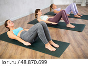 Young woman practicing pilates exercises in yoga studio. Стоковое фото, фотограф Яков Филимонов / Фотобанк Лори