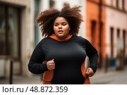 Determined overweight woman, adorned in a bold black and orange ensemble, fearlessly sprints down the bustling urban road. Стоковое AI-изображение, AI-художник Данила Большаков / Фотобанк Лори