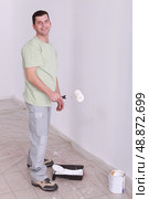 Man painting wall with roller. Стоковое фото, агентство Ingram Publishing / Фотобанк Лори