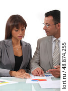 Two businesspeople going over results. Стоковое фото, агентство Ingram Publishing / Фотобанк Лори