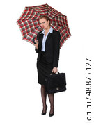 Austere businesswoman holding a briefcase and an umbrella. Стоковое фото, агентство Ingram Publishing / Фотобанк Лори
