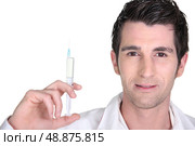 Doctor holding up an injection. Стоковое фото, агентство Ingram Publishing / Фотобанк Лори