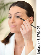 Woman applying make-up. Стоковое фото, агентство Ingram Publishing / Фотобанк Лори