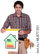 A male carpenter promoting energy savings. Стоковое фото, агентство Ingram Publishing / Фотобанк Лори