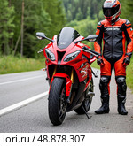 Red sport motorcycle parked on roadside, surrounded by greenery, with rider in black and orange gear standing beside it. Rider wears helmet, obscuring facial details. Стоковое AI-изображение, AI-художник Olga Dmitrieva / Фотобанк Лори