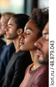 Meditation session in a tranquil setting with diverse individuals practicing mindfulness. Стоковое AI-изображение, AI-художник Александр Довянский / Фотобанк Лори