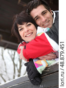 Couple stood on the patio of there holiday chalet. Стоковое фото, агентство Ingram Publishing / Фотобанк Лори