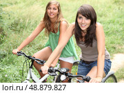 Two girls on a bicycle. Стоковое фото, агентство Ingram Publishing / Фотобанк Лори