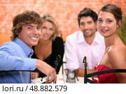 Family sat in restaurant. Стоковое фото, агентство Ingram Publishing / Фотобанк Лори