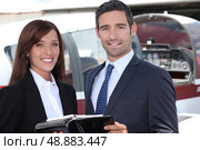Couple standing by the cockpit of a light aircraft. Стоковое фото, агентство Ingram Publishing / Фотобанк Лори