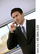 Concerned businessman holding cellphone. Стоковое фото, агентство Ingram Publishing / Фотобанк Лори
