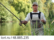 Man fishing in river. Стоковое фото, агентство Ingram Publishing / Фотобанк Лори
