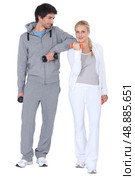 Couple working out at the gym together. Стоковое фото, агентство Ingram Publishing / Фотобанк Лори