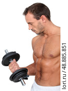 Muscular man lifting a dumbbell. Стоковое фото, агентство Ingram Publishing / Фотобанк Лори