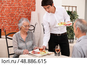 Senior couple being served food in a restaurant. Стоковое фото, агентство Ingram Publishing / Фотобанк Лори