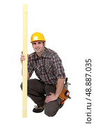 Carpenter holding a plank of wood. Стоковое фото, агентство Ingram Publishing / Фотобанк Лори
