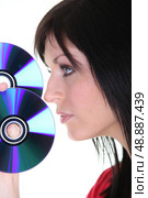 a brunette woman and discs. Стоковое фото, агентство Ingram Publishing / Фотобанк Лори