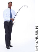 Man in a shirt and tie using a fishing rod. Стоковое фото, агентство Ingram Publishing / Фотобанк Лори