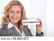 Woman in a suit holding a Service Communication" sign" Стоковое фото, агентство Ingram Publishing / Фотобанк Лори