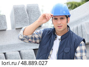 Construction worker in a hardhat next to concrete kerbing. Стоковое фото, агентство Ingram Publishing / Фотобанк Лори