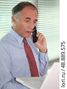 mature businessman on the phone looks stunned. Стоковое фото, агентство Ingram Publishing / Фотобанк Лори