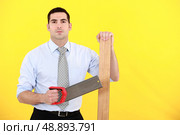 Professional holding a saw. Стоковое фото, агентство Ingram Publishing / Фотобанк Лори