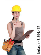 Tradeswoman completing an evaluation. Стоковое фото, агентство Ingram Publishing / Фотобанк Лори