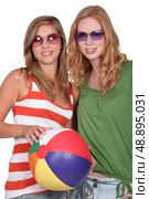 Two girlfriends with a beachball. Стоковое фото, агентство Ingram Publishing / Фотобанк Лори