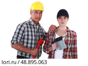 Tradespeople holding tools. Стоковое фото, агентство Ingram Publishing / Фотобанк Лори