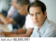 Handsome young man in an office environment. Стоковое фото, агентство Ingram Publishing / Фотобанк Лори
