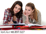 Two girls revising together. Стоковое фото, агентство Ingram Publishing / Фотобанк Лори
