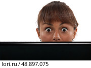 Woman peering over her laptop. Стоковое фото, агентство Ingram Publishing / Фотобанк Лори