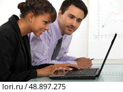 young businessman and businesswoman working together. Стоковое фото, агентство Ingram Publishing / Фотобанк Лори