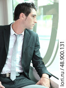 Businessman going to work on tram. Стоковое фото, агентство Ingram Publishing / Фотобанк Лори