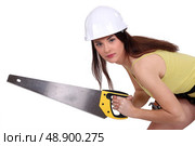 charming craftswoman holding saw. Стоковое фото, агентство Ingram Publishing / Фотобанк Лори