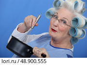 Cheeky older woman in rollers. Стоковое фото, агентство Ingram Publishing / Фотобанк Лори