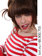 brunette wearing red and white striped shirt making grimace. Стоковое фото, агентство Ingram Publishing / Фотобанк Лори