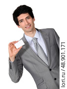 portrait of handsome businessman holding business card. Стоковое фото, агентство Ingram Publishing / Фотобанк Лори